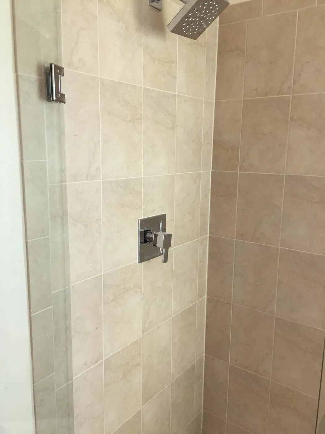 Bathroom tile installation showing properly bonded tile and grout — Orlando remodel