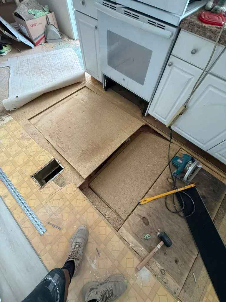 Damaged subfloor panel being removed from a Winter Garden kitchen