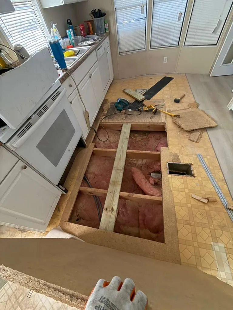 Wide view of subfloor demolition in a Winter Garden kitchen