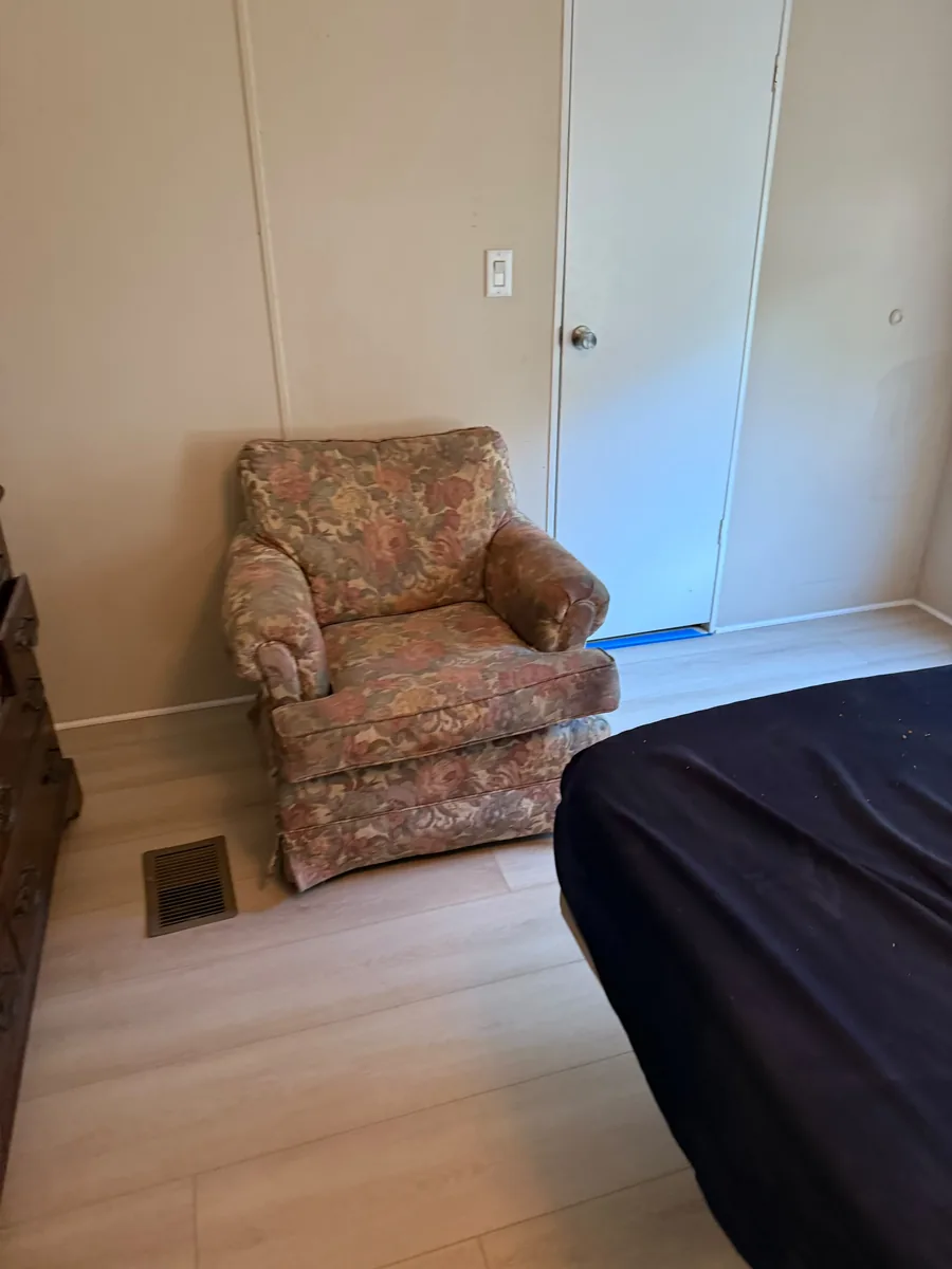 Completed vinyl flooring beside an armchair in a Winter Garden bedroom