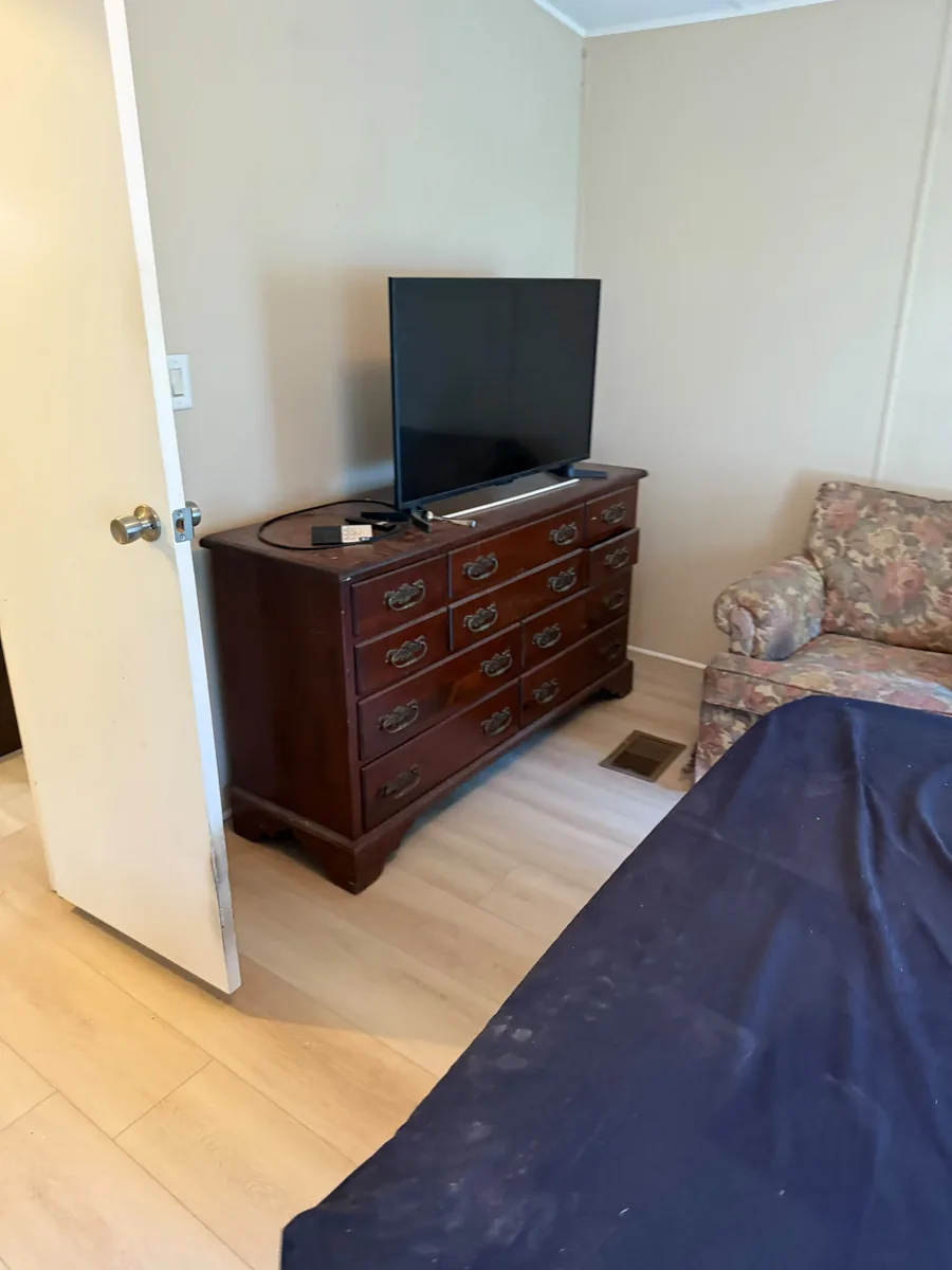 Completed vinyl flooring in a Winter Garden bedroom dresser area