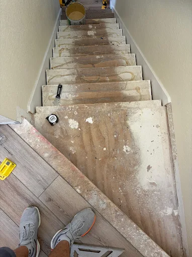Original staircase before vinyl stair tread installation